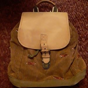 A brown bag with red foxes on it